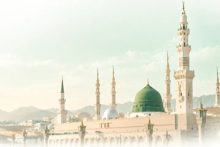 The green dome and the minarets of the Prophet's Mosque in Medina in soft morning light