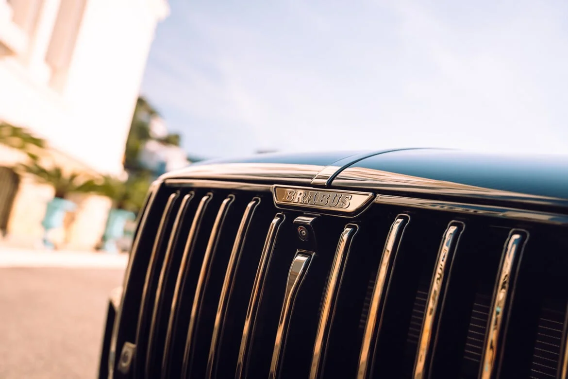BRABUS BODO grille close-up — signature vertical-bar chrome grille with BRABUS emblem